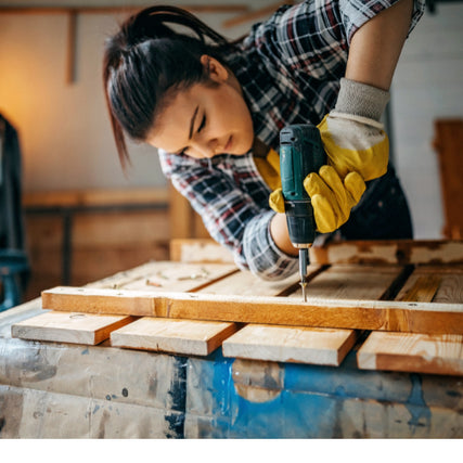 Do It Yourself RentalsWoman using a blue power drill on wood