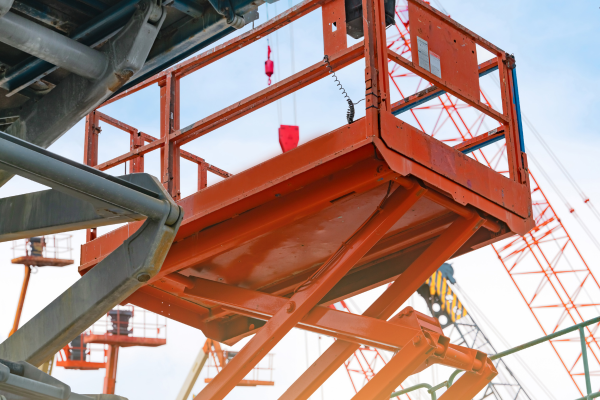 Orange boom lift at sunset